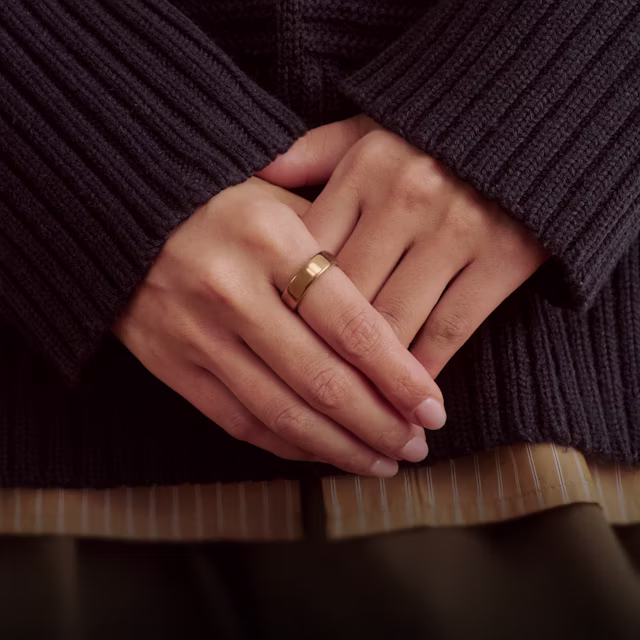 Gros plan sur les mains d’une personne posées devant elle, la KEORA Ring 6 Deep Rose au doigt